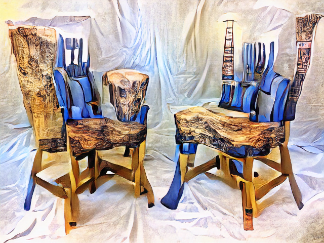 Two chairs face each other. Their seats are thick knotted pieces of wood and their backs are blue cartoonish paint alternating with carved pillars. The legs are highly distorted.