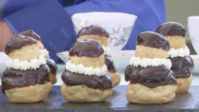 Each pastry is made of two round choux buns, dipped in chocolate and stacked together with cream.