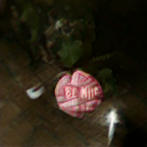 A dark background with a vaguely circular candy. It looks very lumpy with embossed lettering. If you knew it was supposed to say "Be Mine" you could recognize it, but none of the letters are quite right.