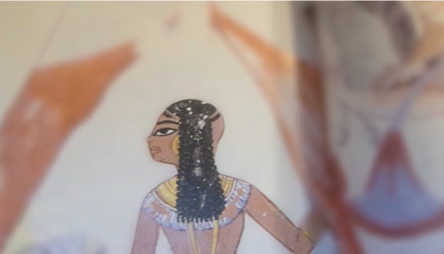 Detail of an ancient egyptian painting. The person’s face and body are in focus, but forearm is blurred. Detail of an ancient egyptian painting. The person’s face and body are in focus, but forearm is blurred.